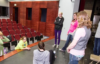 students on theatre stage