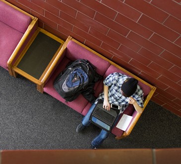 looking down on student with laptop