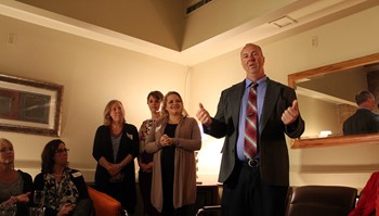 Nucleus Clinic Open House attendees listen to Anoka-Ramsey Community College President Kent Hanson speak about the importance of the college’s new partnership with the clinic.