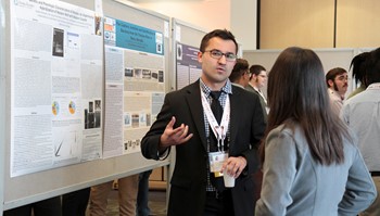 An Anoka-Ramsey Community College student discusses his undergraduate research as part of the college’s Outstanding Scholarship, Creative Activities and Research Symposium (OSCARS).