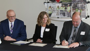 (from left) Al Gerhardt, Kraus-Anderson Construction Company Chief Operating Officer and President, Jodie Greising, Director of MJSP and Kent Hanson, Anoka-Ramsey Community College President, sign a $394,279 Minnesota Job Skills Partnership (MJSP) grant that will allow the college to provide customized training and development to 500 employees at Kraus-Anderson. 