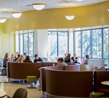 Students seated in campus dining area.