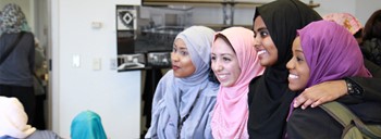 Four female students in Muslim garb pose for a picture.