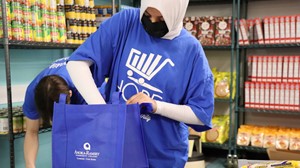 Student employees prepare food bags before food pantry opening.