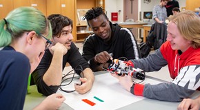 serveral students in engineering lab studying model